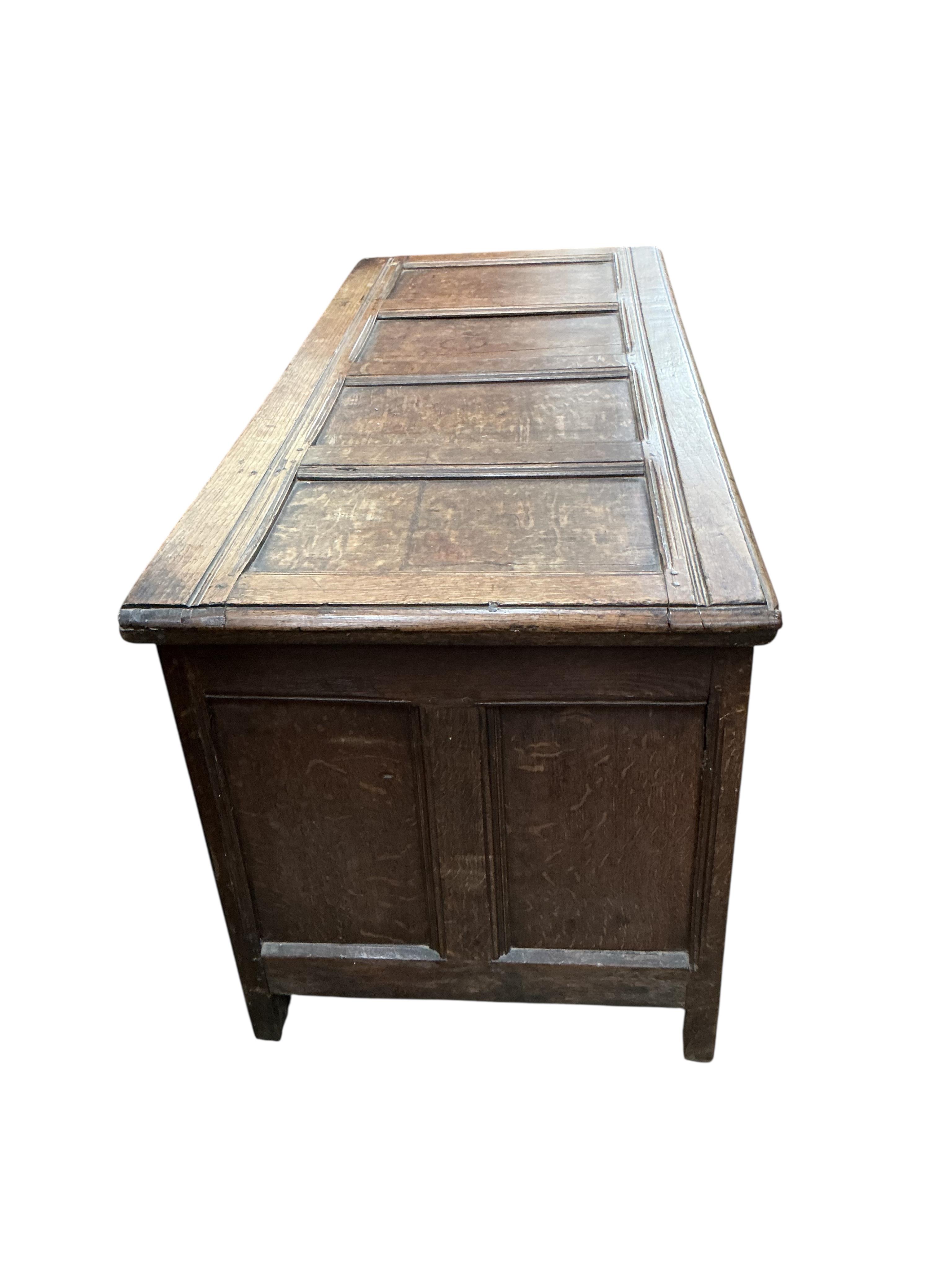 An 18th century panelled oak coffer, width 130cm, depth 55cm, height 61cm